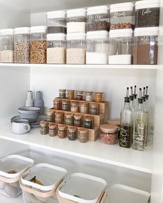 the kitchen cabinets are organized with clear containers