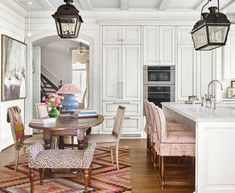 a kitchen and dining room with white cabinets