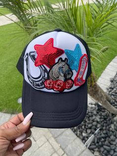 Embrace a playful western vibe with our Howdy Trucker Hat! This custom hat features vibrant patches, including a horse, horseshoe, red roses, western boot and sequin stars, adding a fun and unique touch. Perfect for women who love trendy accessories, this custom trucker cap combines style and comfort with its breathable mesh back. Whether you're heading to a festival, a casual outing, or just want to add some flair to your everyday look, this hat is your go-to choice. Stand out and express your fun side with this stylish and eye-catching trucker hat! High quality patches with adjustable SnapBack hat.   💞SHIPPING  We have a 3-5 (business days) processing/shipping turnaround time.  Most orders ship out within 1-2 business days. Western Multicolor Cap, Western Style Multicolor Cap, Multicolor Hat For Rodeo, Hat With Patches, Hat Bar, Horse Western, Western Hat, Cowgirl Hat, Hat Ideas