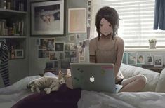 a woman sitting on her bed using a laptop computer with a cat laying next to her