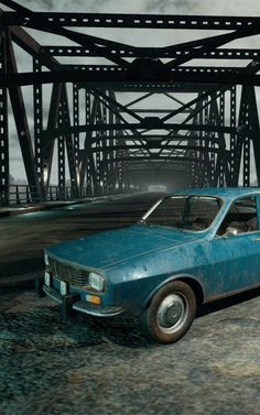 an old blue car parked in front of a bridge