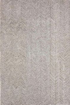 an area rug with white and gray herringbones