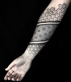 a person's arm with a tattoo on it and an intricate design in the middle