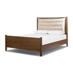 a wooden bed frame with white pillows on top of it and a headboard in the middle