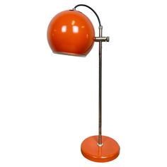 an orange table lamp with a metal base