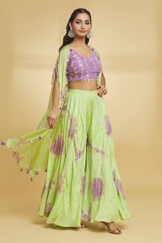 Purple and green cape with gota embroidery. Paired with an embroidered blouse and flared palazzo. - Aza Fashions Green Cotton Sharara With Sheer Dupatta, Bohemian Green Choli With Sheer Dupatta, Designer Summer Choli In Green, Designer Green Choli For Summer, Spring Green Sharara With Sheer Dupatta, Traditional Green Choli For Spring, Summer Green Choli For Designer Occasions, Pista Green Saree Set For Spring, Designer Summer Green Choli