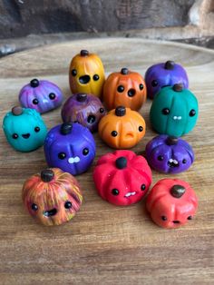 there are many small pumpkins with faces painted on them