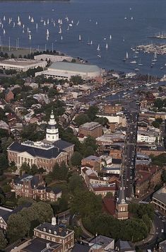 an aerial view of a city with boats in the water