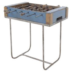 an old style foosball table with metal legs