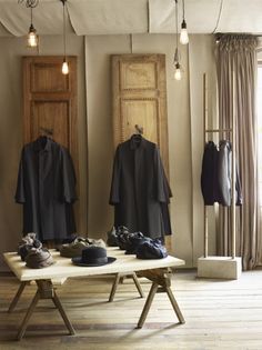 an open room with clothes hanging on the wall