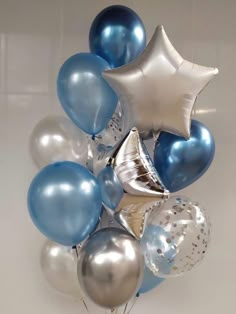 a bunch of blue and silver balloons in a vase