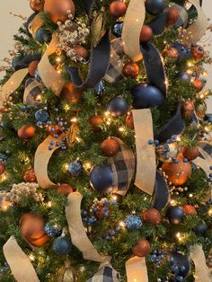 a decorated christmas tree with blue and gold ornaments