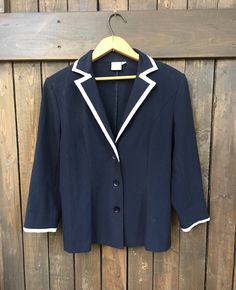 Vintage 1980's navy blue with white trim blazer.  ' Look fab all summer long prancing around at the office or on the seaside in this sailor blazer' - Sailor style with large collar.  - 3/4 length sleeves.  - 3 button down with small shoulder pads.  - Two slight fitted pleats down back.  - Manufactured by Cleo.  - Size 4 - In good, vintage condition showing minor wear and age. - Sparse wear around sleeve cuffs.  Measurements taken lying flat: ( already doubled) Length: 23.5" Width: 34" Neckline: Short Blazer Outfits, Sailor Jacket, Girls Blazers, Nautical Outfits, Summer Blazer, Blazer Outfits For Women, Sailor Style, Navy Sailor, Sailor Fashion