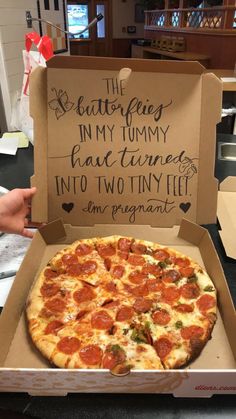 a pizza with pepperoni and cheese in a box that says the boutiquefey inn my tummy has turned into two tiny jeff's on pregnant