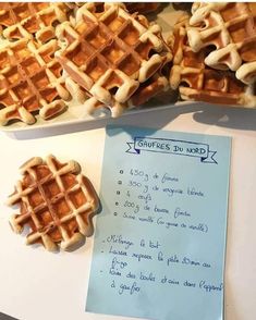 some waffles are sitting on a table next to a piece of paper