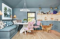 a dog is standing in the middle of a room with blue walls and wooden floors