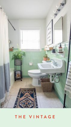 a bathroom with a rug, sink and mirror on the wall in front of it