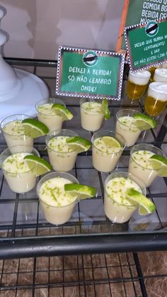 small cups filled with drinks on top of a metal rack