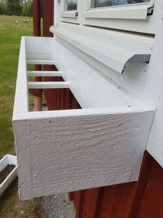 the side of a house with a window and gutter