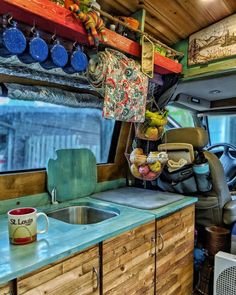 the interior of a van with various items hanging from it's roof rack and sink