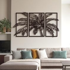 a living room with couches and paintings on the wall above them, along with a coffee table