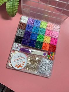 a plastic container filled with lots of different colored beads