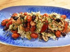 a blue plate topped with rice and vegetables