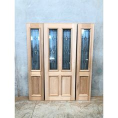 three wooden doors with glass panels on each side