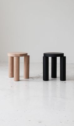 three stools sitting on top of a white floor