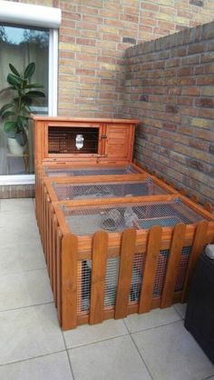 a bed made out of wooden crates on top of a tiled floor next to a brick wall