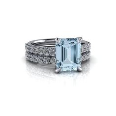 an aqua blue topazte and diamond ring with two rows of diamonds around it