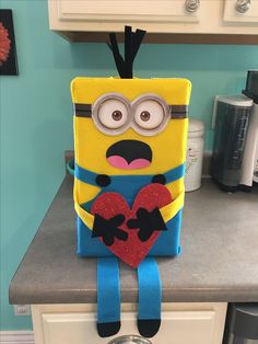 a yellow and blue bag with a heart on it sitting on top of a counter