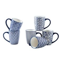 four blue and white coffee mugs sitting next to each other on a white surface