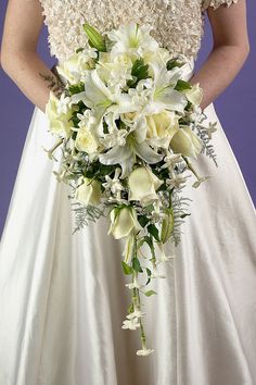 a woman in a wedding dress holding a bouquet