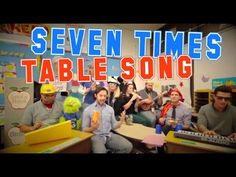 seven times table song with people sitting around and one man standing in front of him