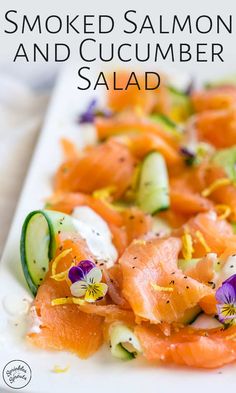 smoked salmon and cucumber salad on a white plate with the words smoked salmon and cucumber salad