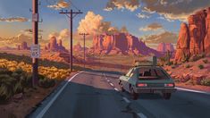 a car is driving down the road in front of mountains and telephone poles at sunset