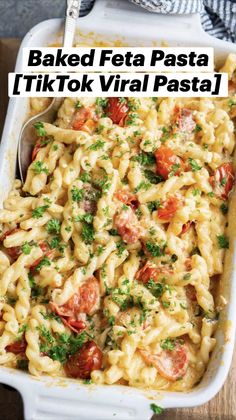 baked feta pasta with tomatoes and parsley in a white casserole dish