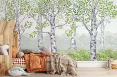 a child's bedroom with trees painted on the wall