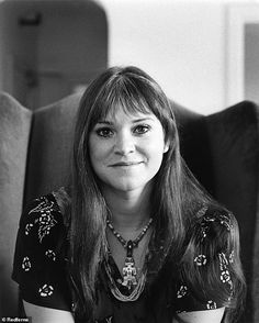 a black and white photo of a woman sitting in a chair