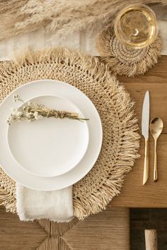 a place setting with white plates and silverware