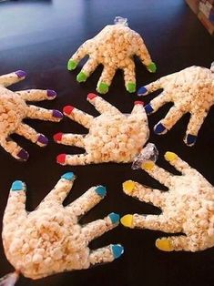 several hands made out of rice krispy kreme cereal on a table next to a laptop