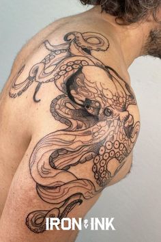 an octopus tattoo on the back of a man's left shoulder and chest is shown