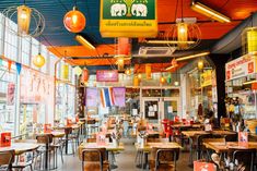 the inside of a restaurant with many tables and chairs