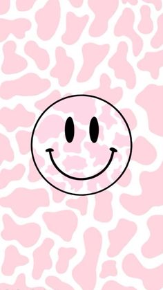 a pink and white pattern with a smiley face on it's back ground,