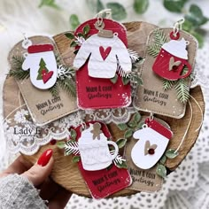 christmas ornament ornaments on a wooden plate with lace and greenery in the shape of mittens