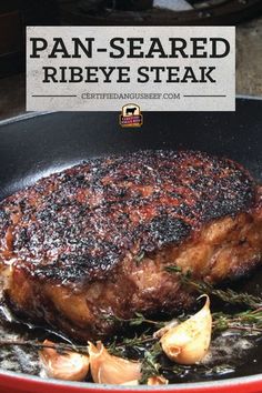 pan - seared ribeye steak in a skillet with garlic and onions