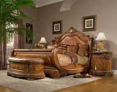 a bedroom scene with focus on the bed and dressers in the background, along with a potted palm tree