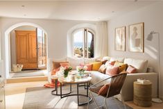 a living room filled with furniture and lots of windows