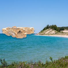 Michigan's Munising beach on a sunny day, with the photo of a gold ring superimposed over the water. ring has the state outline of michigan's upper and lower peninsulas Michigan Beaches, Upper Peninsula, Unique Ring, Great Lakes, Stone Settings, Unique Rings, Lab Grown Diamonds